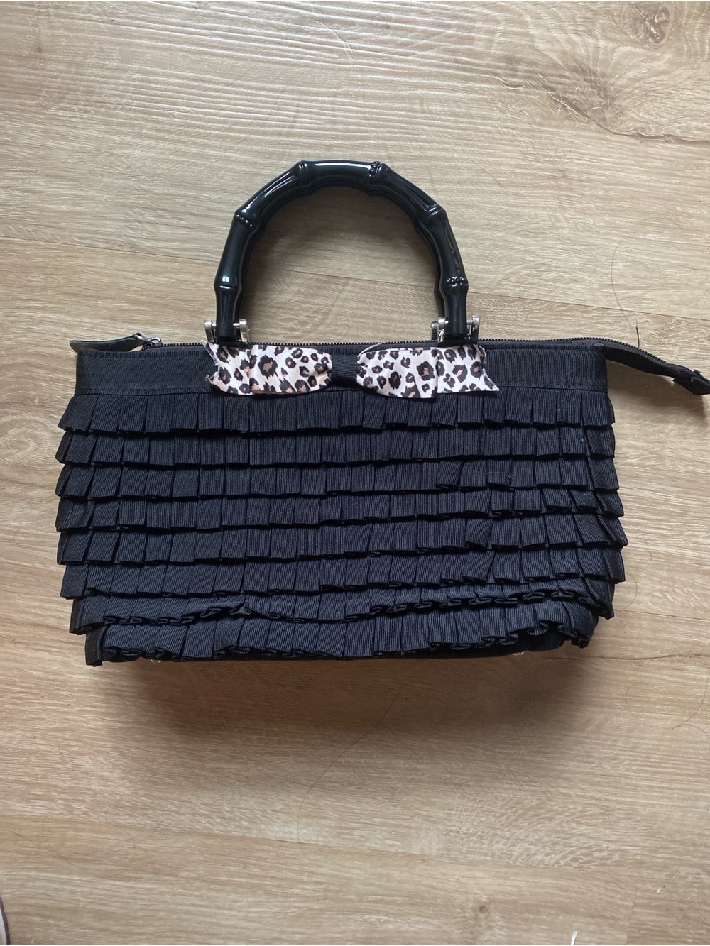 Braciano Black Ruffle Handbag with Leopard Bow Accent
